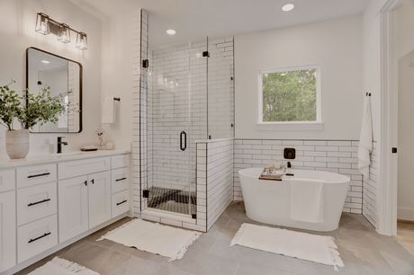 Primary bathroom shower and soaking tub at Marcella Estates