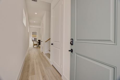 Entry hallway of an Archers Villas townhome with a sage-green interior door
