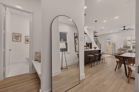 Entry hallway at Donovan Vista with an arched floor mirror