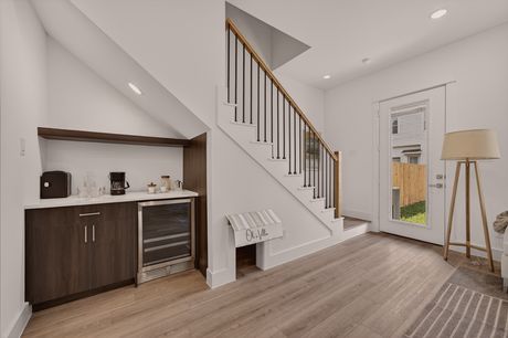 Foyer with wet bar nook and stairway at Donovan Vista