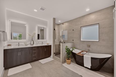 Primary bathroom with soaking tub and glass shower at Donovan Vista