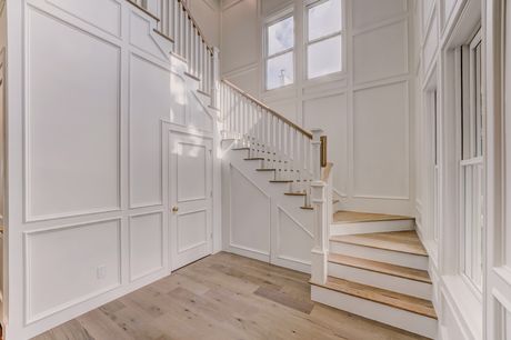 Staircase and wainscoted stairwell at the Stephan Custom Residence