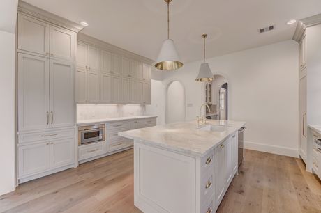 Kitchen cabinetry and butler's pantry archway at the Stephan Custom Residence