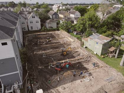 Aerial view of foundation trenches with plumbing stub-outs at Residences on 24th