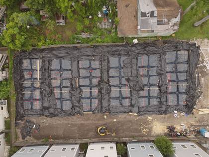 Aerial view of vapor-barrier-wrapped rebar foundations before the pour at Residences on 24th