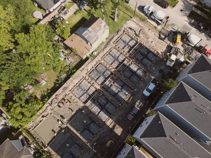 Aerial view of poured foundations and wood framing underway at Residences on 24th
