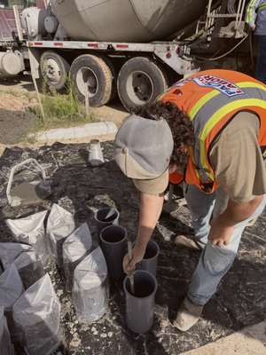 Crew member preparing plumbing sleeves before a concrete pour at Mockingbird Place