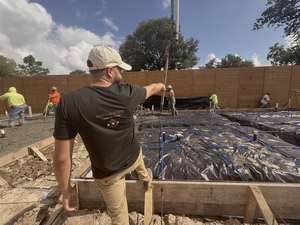 Setting Stone Construction team member directing a concrete pour at Mockingbird Place