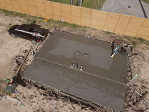 Aerial view of a finished foundation slab being floated at Mockingbird Place